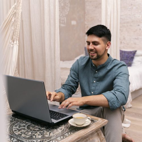 full-shot-smiley-man-working-laptop full-shot-smiley-man-working-laptop